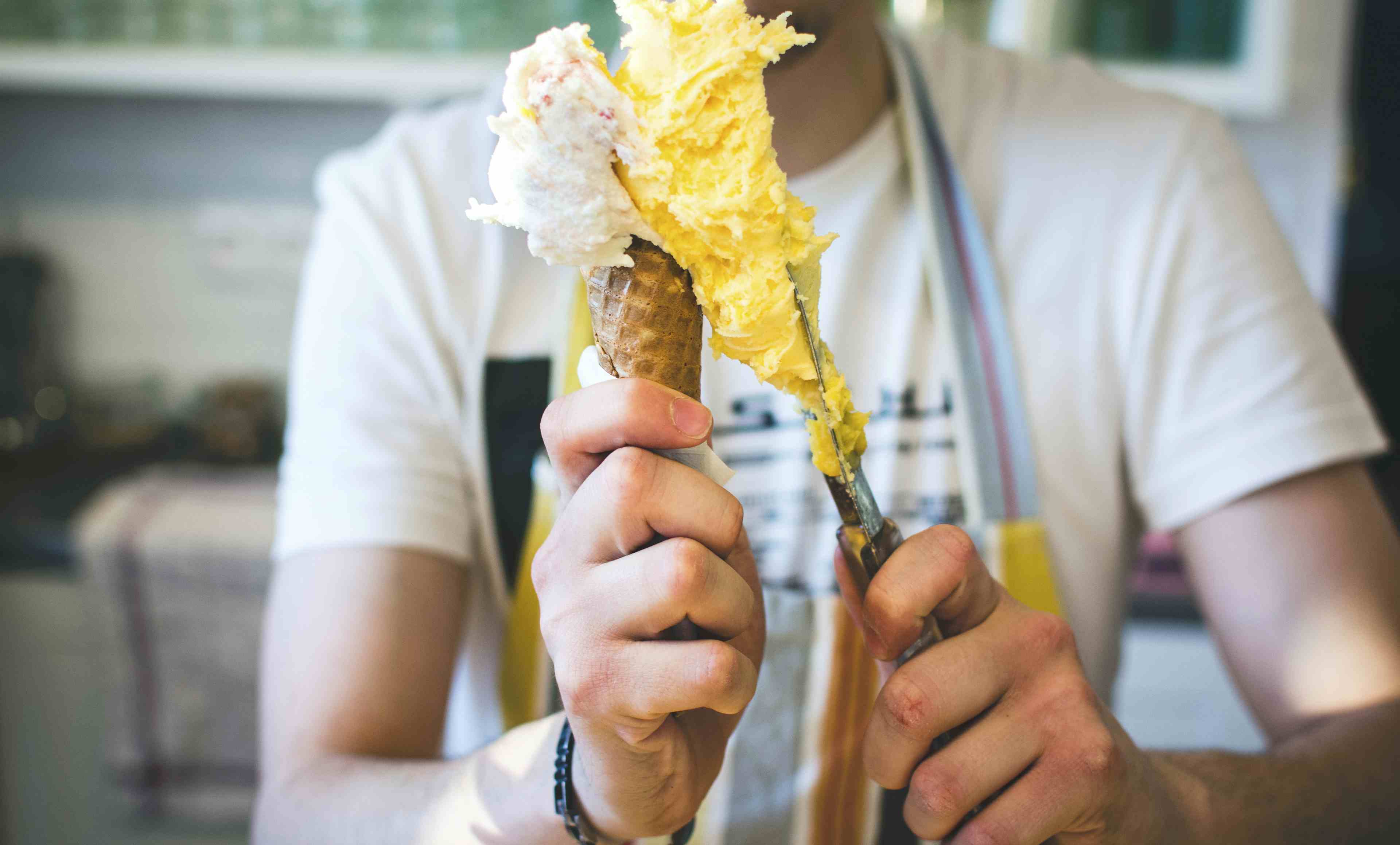 A photo of ice cream being served in a cone